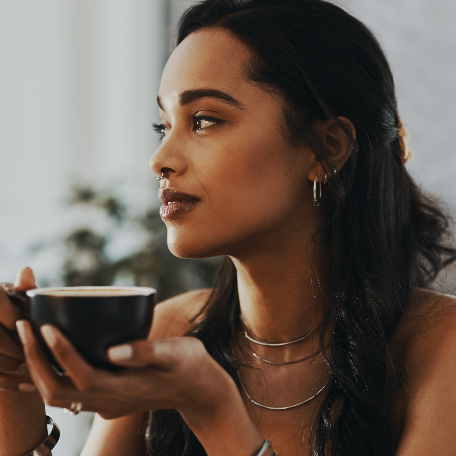 Woman with a warm beverage. 